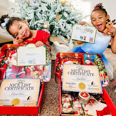 Happy sisters with personalized Letters From Santa from Package From Santa®!