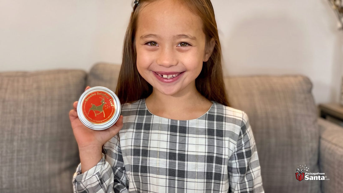 Smiling girl holding a tin of genuine reindeer food from the North Pole
