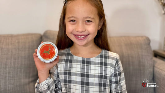 Smiling girl holding a tin of genuine reindeer food from the North Pole
